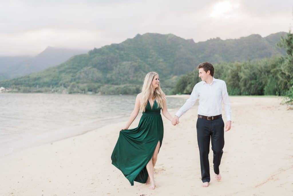 couple walking on the beach at kualoa regional park on Oahu