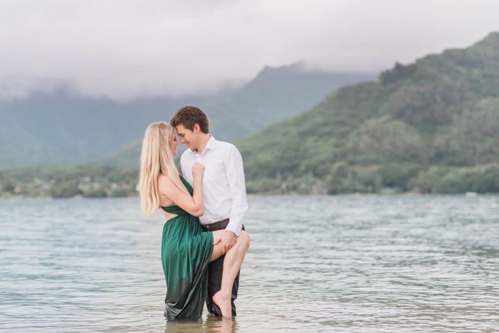 bride and groom in the water in Oahu, Hawaii