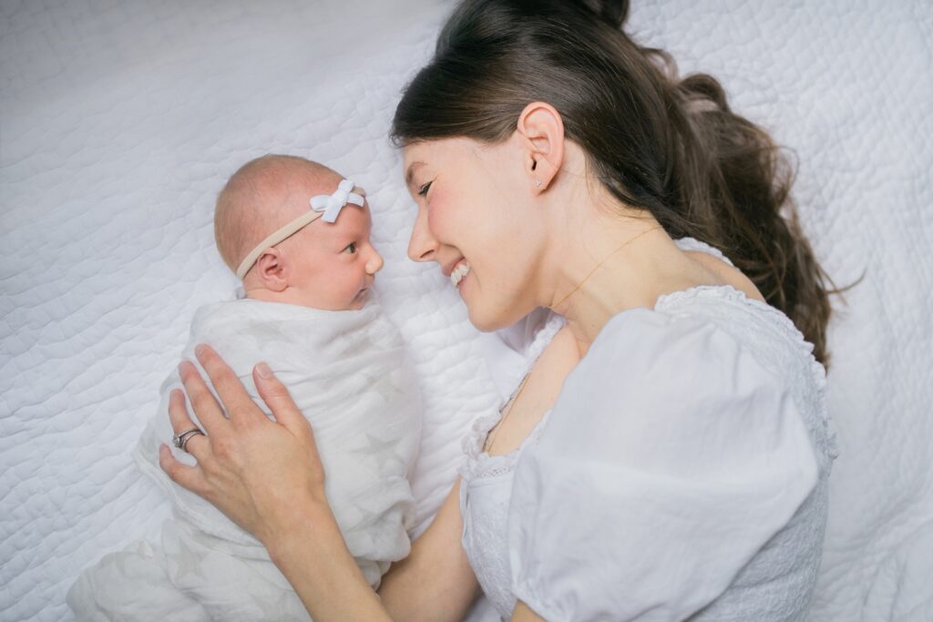 Chapel Hill Newborn Photographer Rae Marshall in Raleigh, mom snuggling with baby