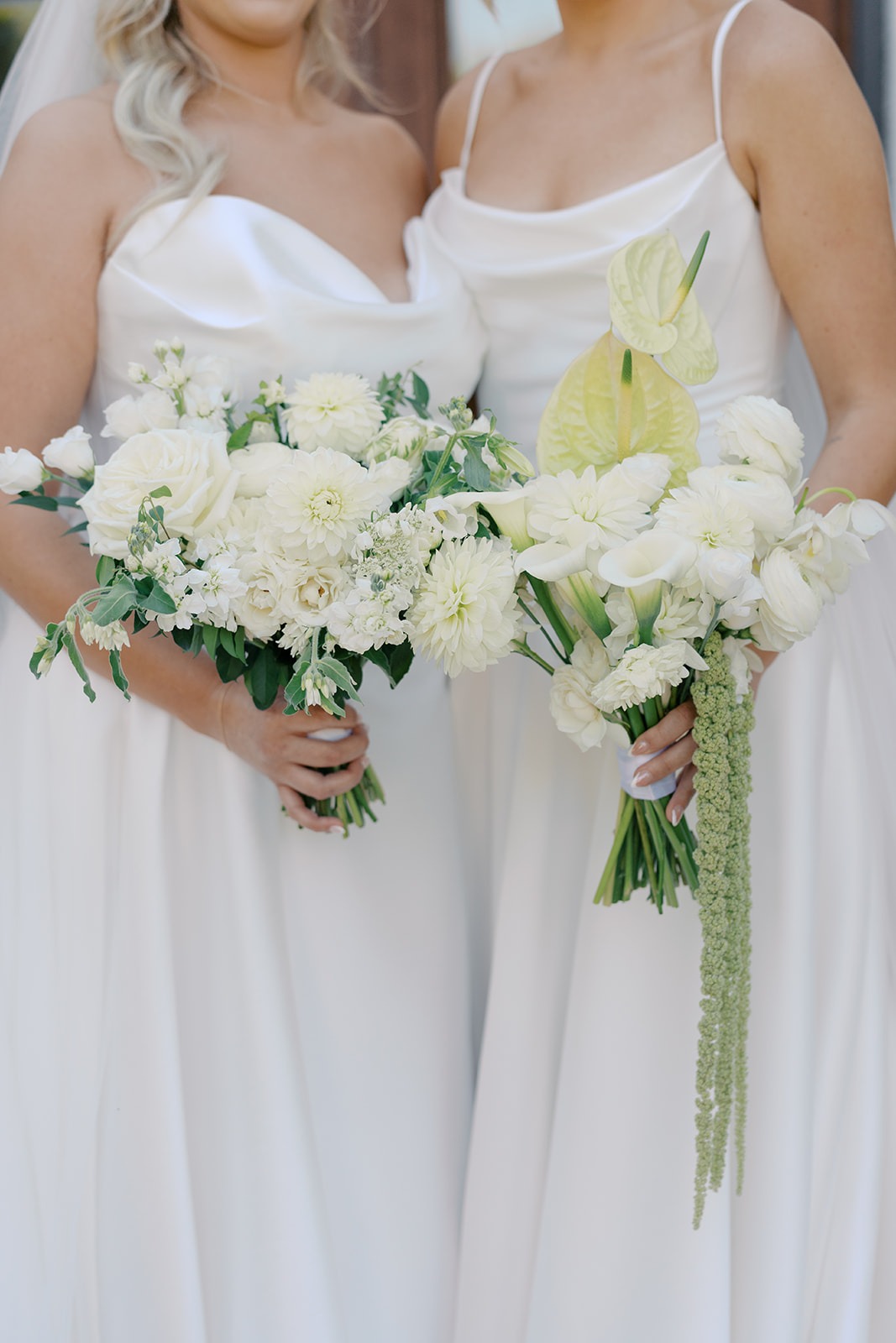 close up of two bridal bouquets with white flowers and anthurium by wild flora