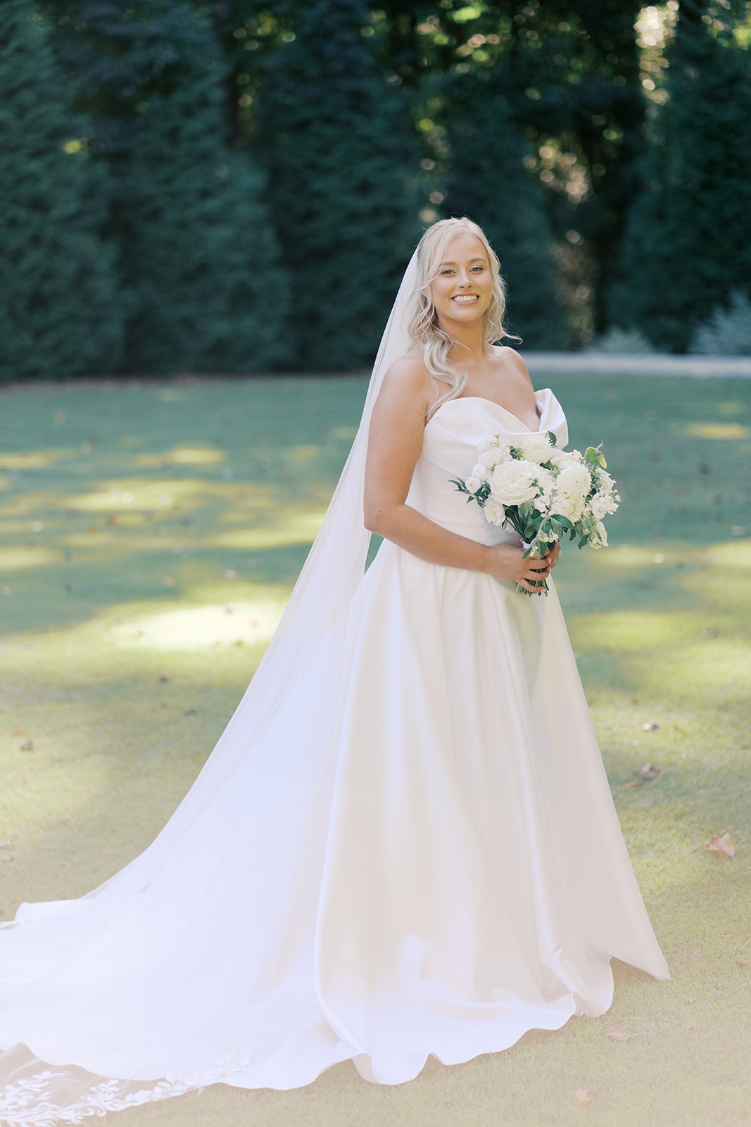 bride in a full veil on the lawn at the bradford in new hill nc