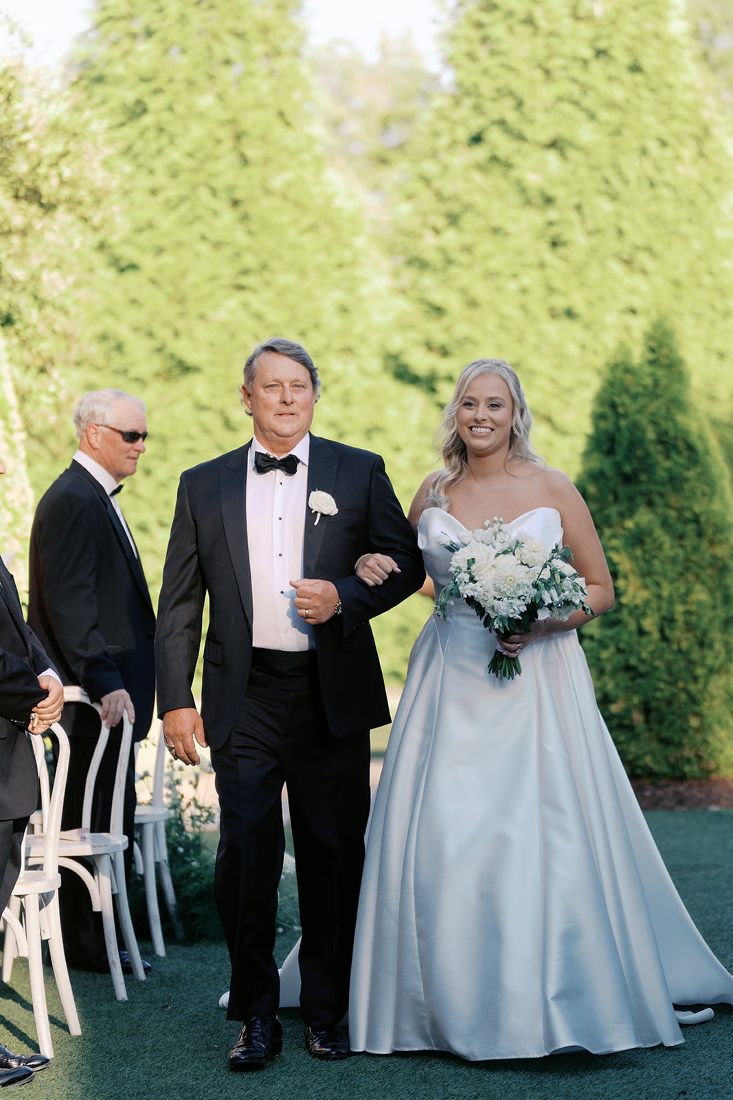bride walked down the aisle by her father at the bradford