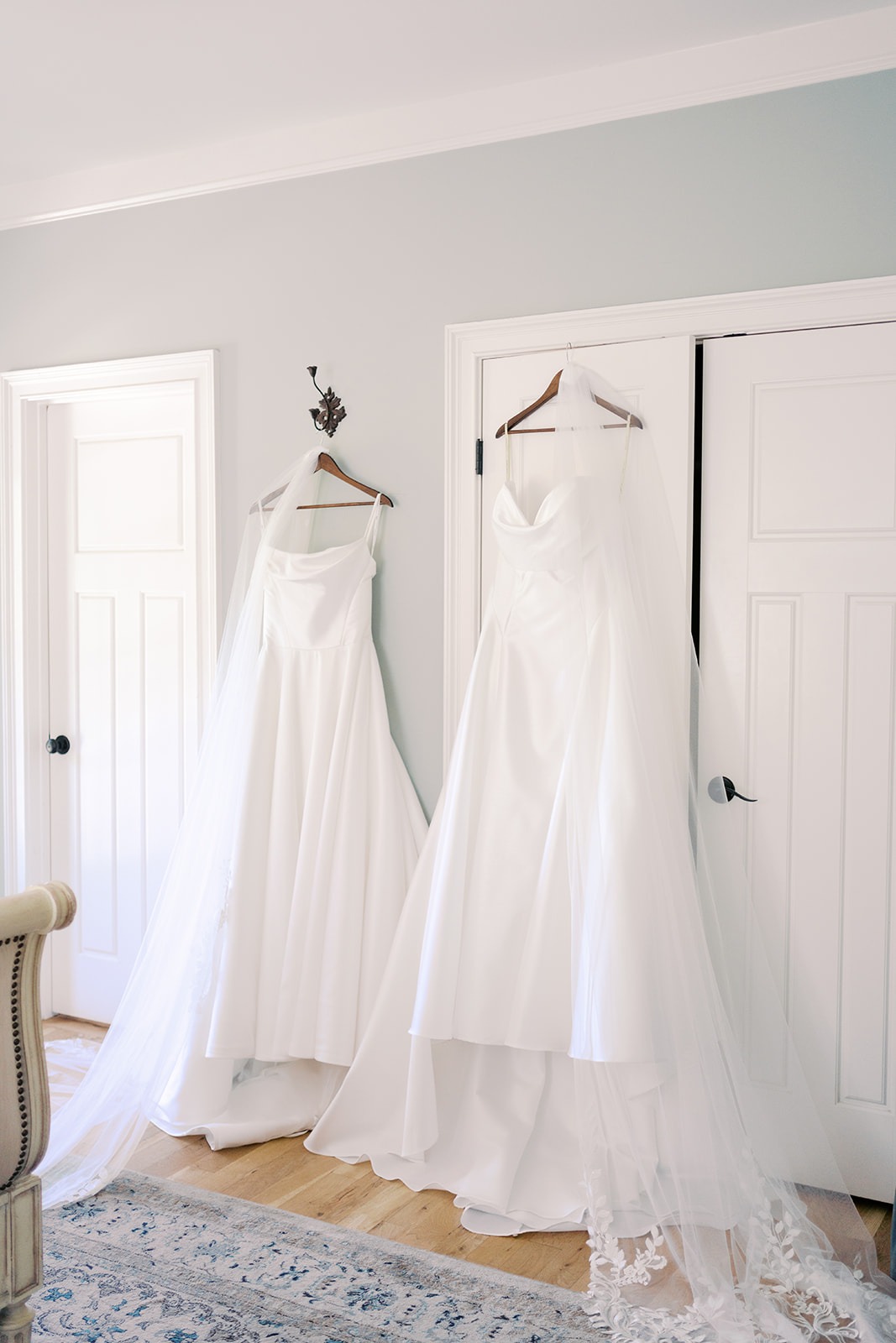 two wedding dresses hanging side by side for a lesbian wedding in north carolina