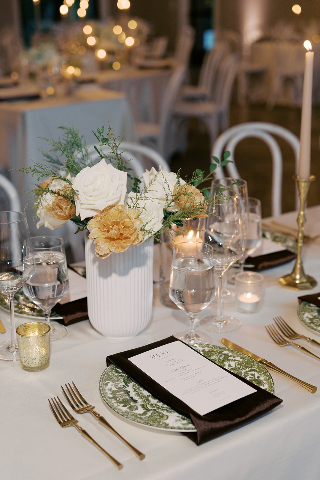 candlelit reception table with white florals at the bradford