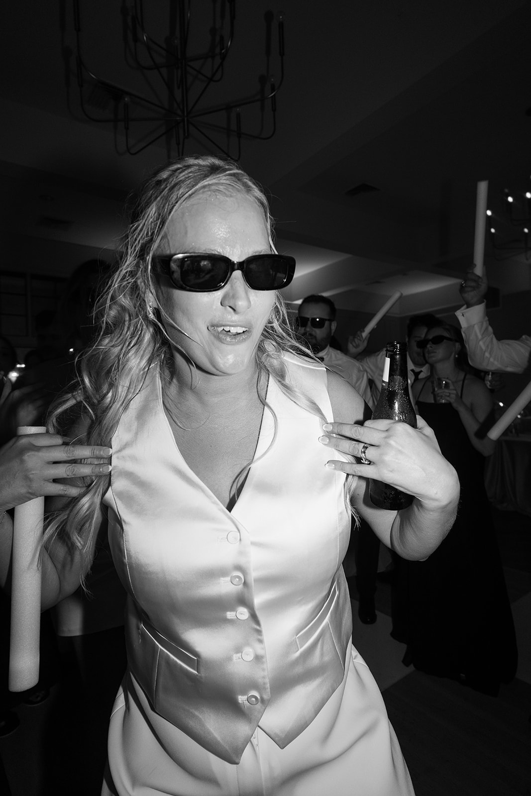 bride dancing in sunglasses at her reception